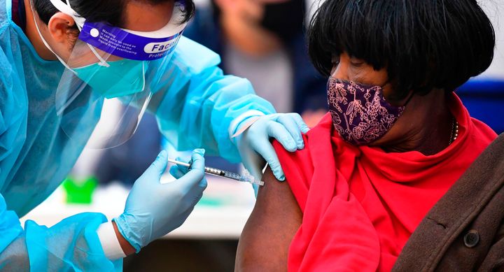 Registered Nurse Angelo Bautista administers the Moderna COVID-19 vaccine to eligible people identified by homeless service agencies from the parking lot of the LA Mission on Feb. 24 in Los Angeles.