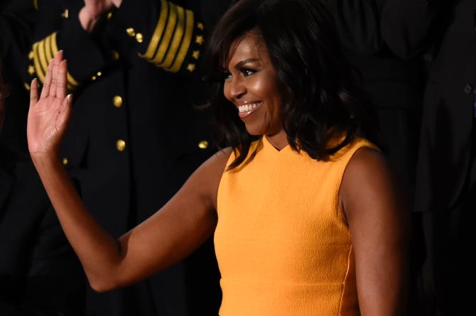 504721566-first-lady-michelle-obama-waves-before-the-arrival-of