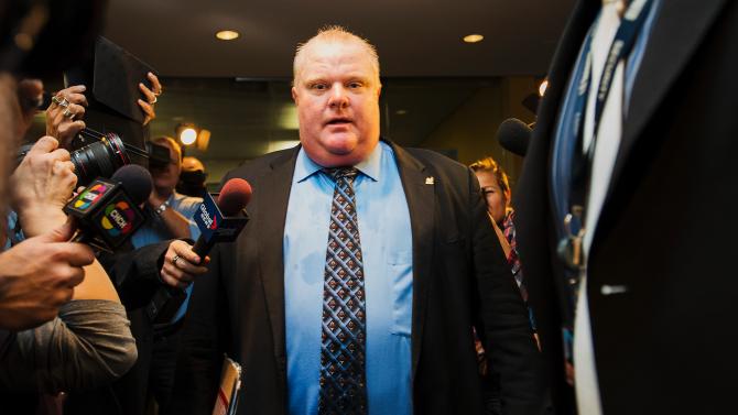 188110889-toronto-mayor-rob-ford-is-swarmed-by-media-at-city-hall