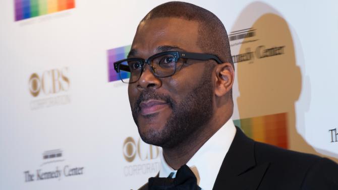 500267932-actor-tyler-perry-poses-with-her-husband-attorney