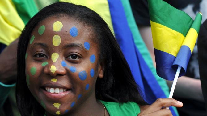 149477451-gabon-supporter-waves-her-national-flag-before-the