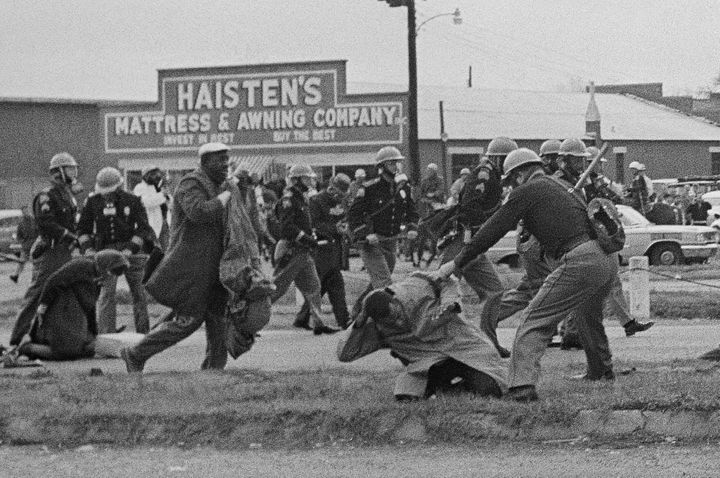 State troopers breaking up a voting rights march in Selma, Alabama, on March 7, 1965. In the foreground, John Lewis, then cha
