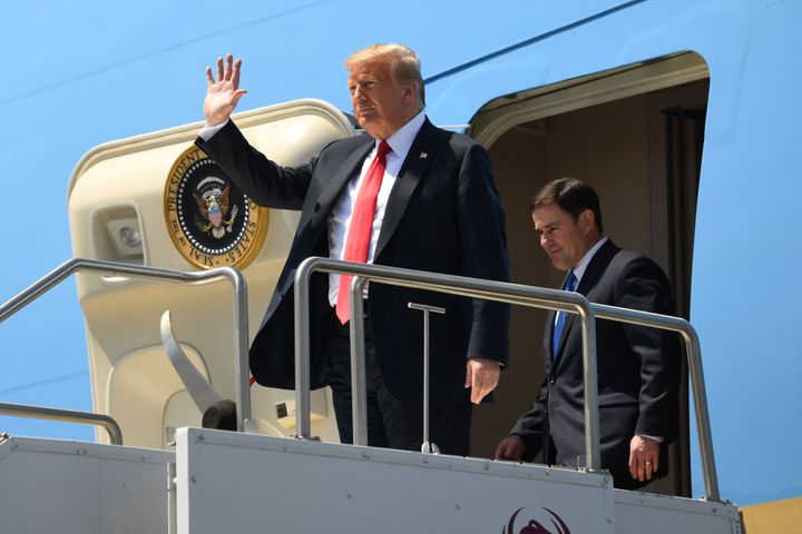 President Donald Trump and Arizona Governor Doug Ducey disembark from Air Force One in June. Ducey has joined in with Trump's